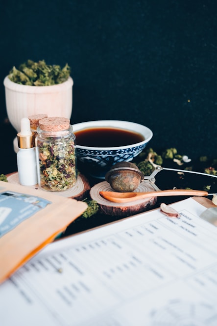 A serene morning scene with herbal teas, supplements, and natural ingredients on a wooden table