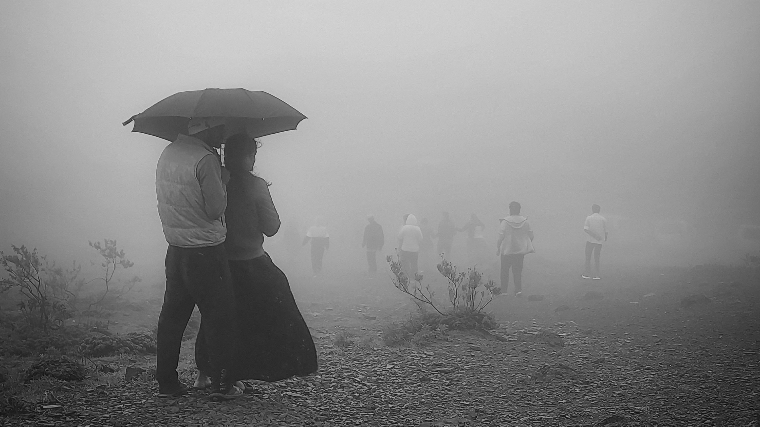 a man and woman holding an umbrella