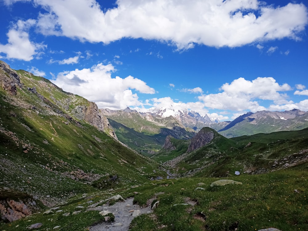 a valley with mountains in the background