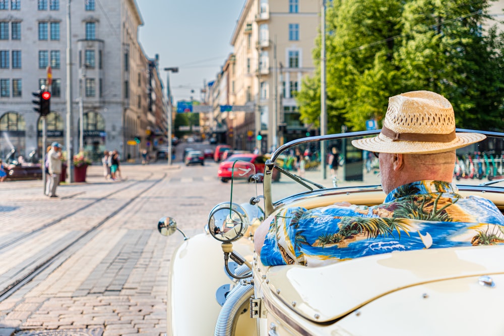 a person in a hat driving a car