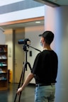 a man with a camera on his tripod