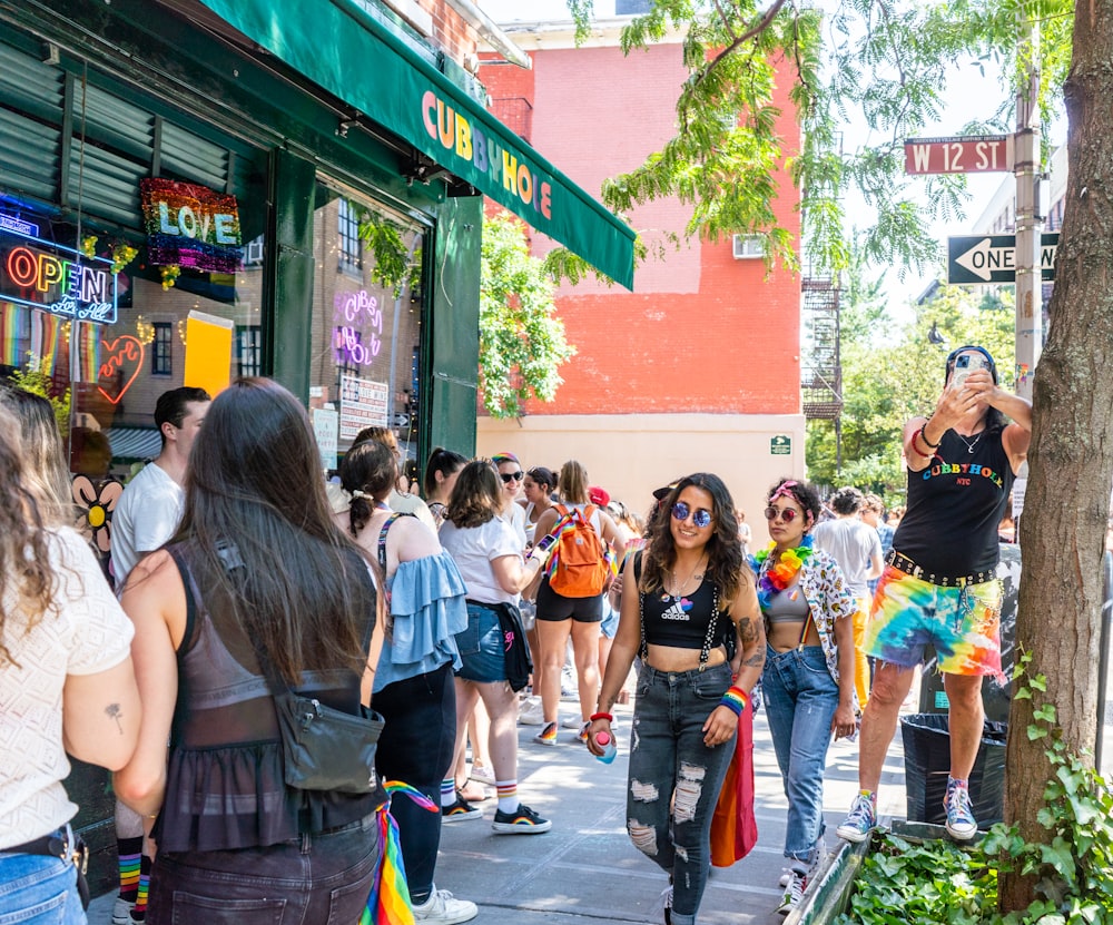 a group of people walking down a sidewalk