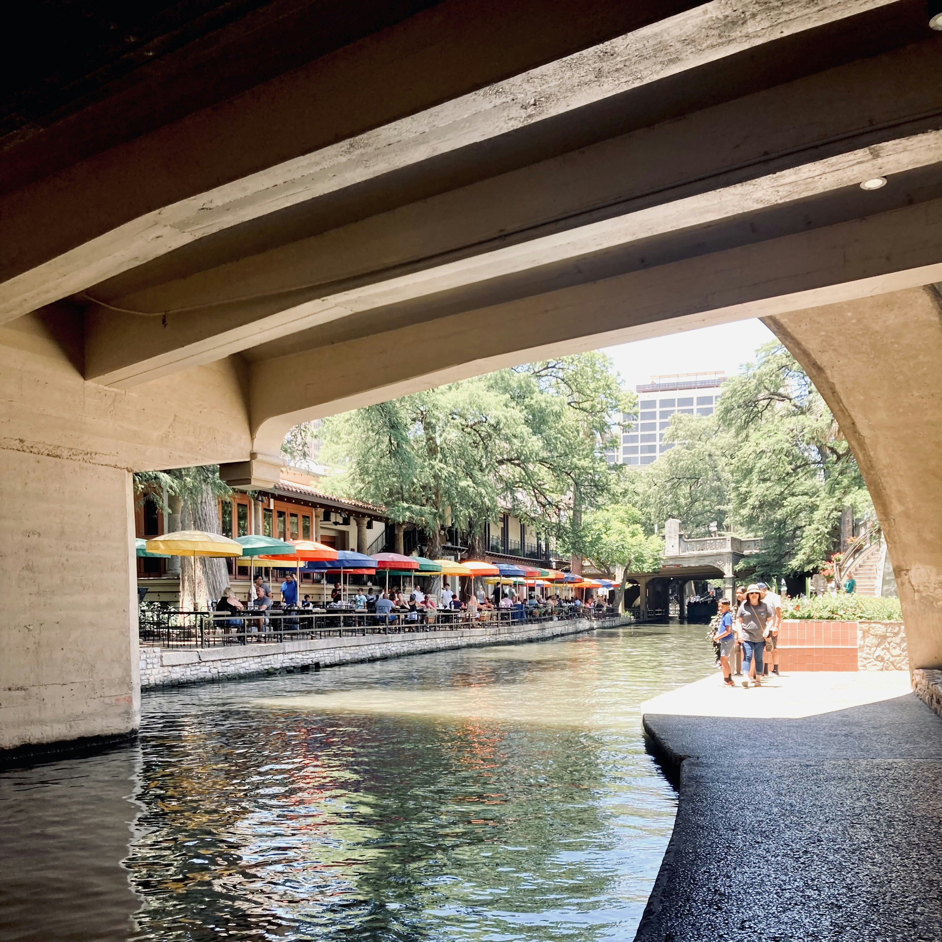 a body of water with buildings and people around it