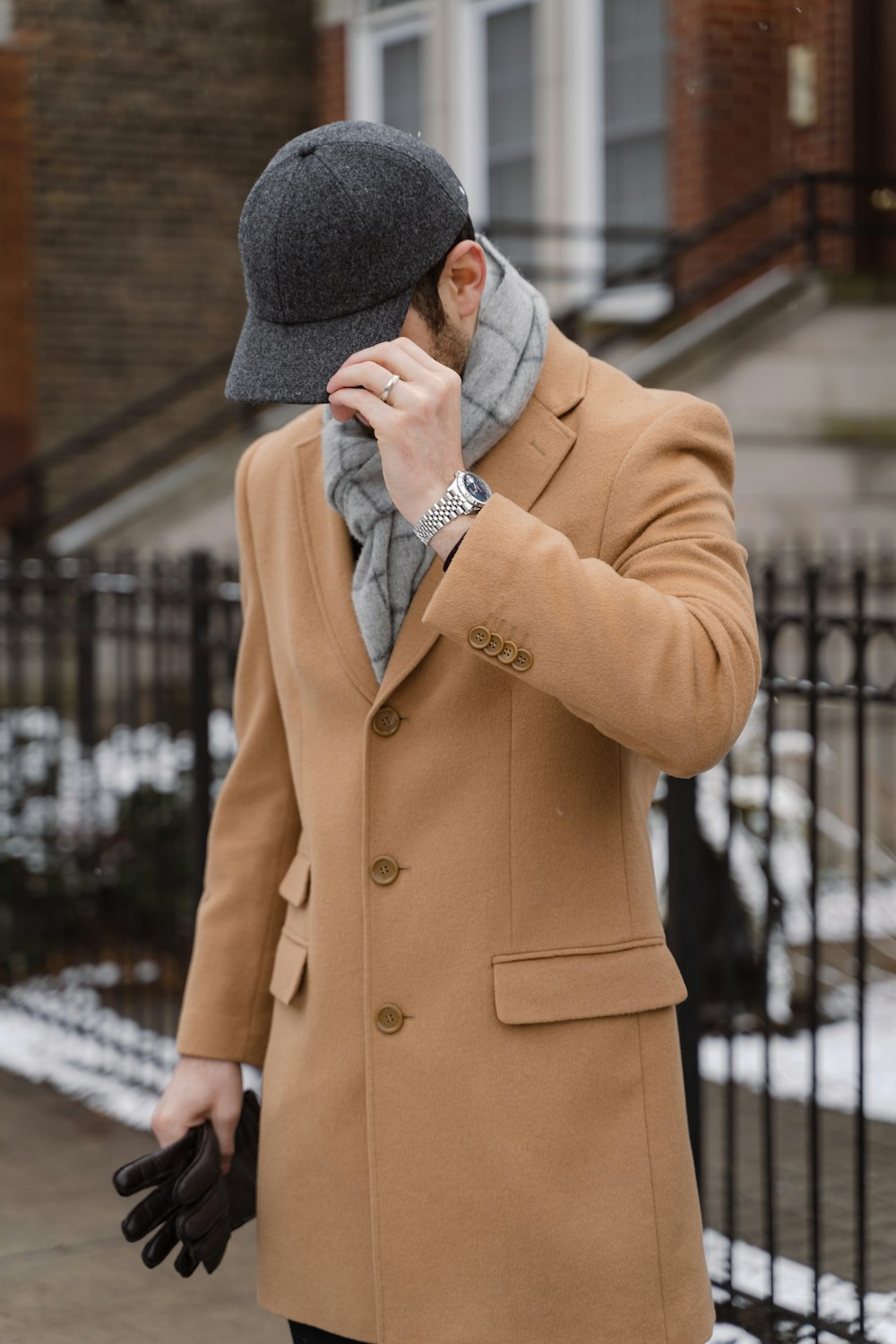 a man in a coat and hat