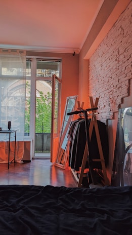 Cozy student hostel room with a study desk and natural light.