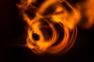 Dynamic strokes of red and orange creating a sense of fiery movement on a dark background.