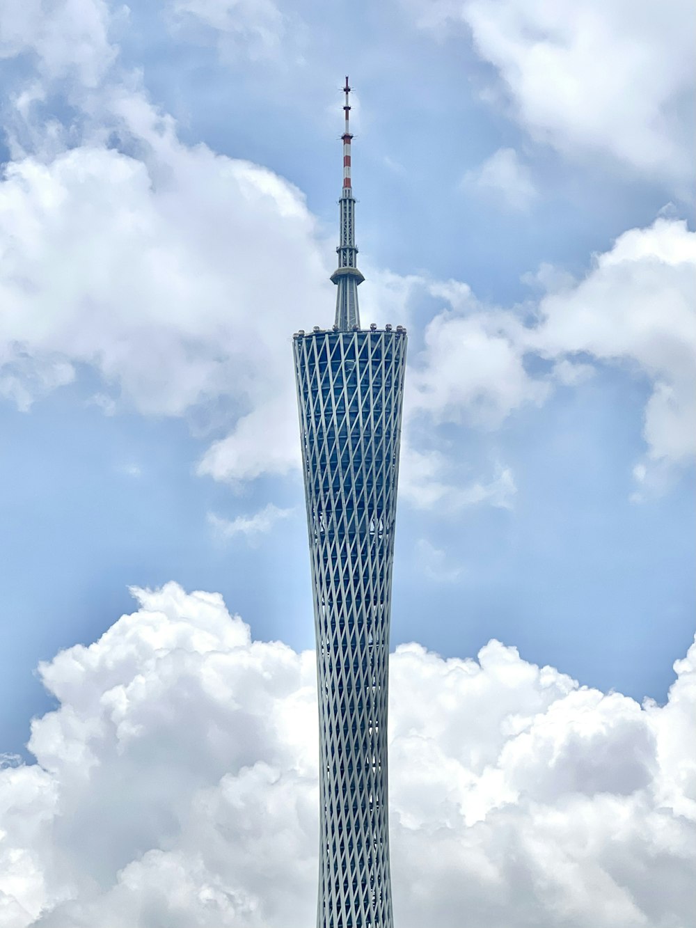 a tall tower with clouds in the background