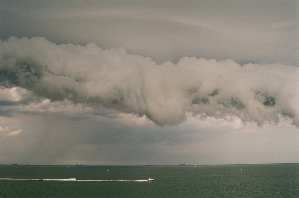 a large storm cloud over the ocean
