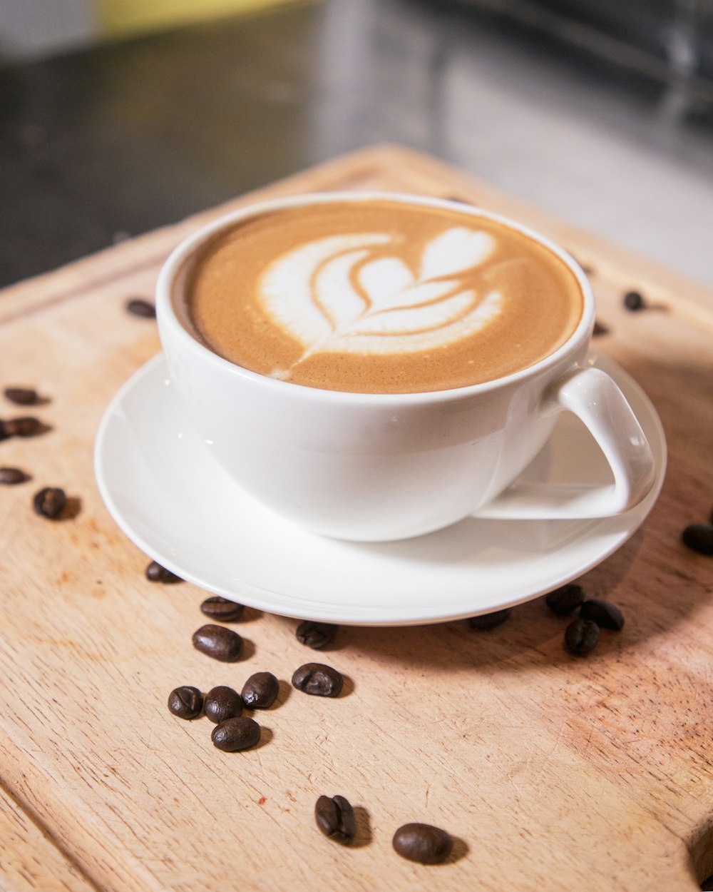 a cup of coffee with coffee beans