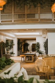 a room with a table chairs and plants