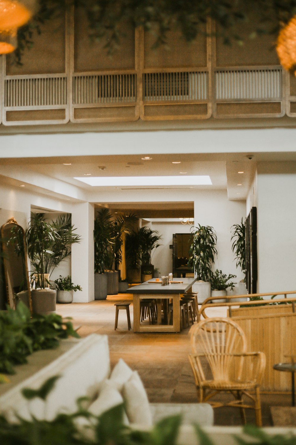 a room with a table chairs and plants