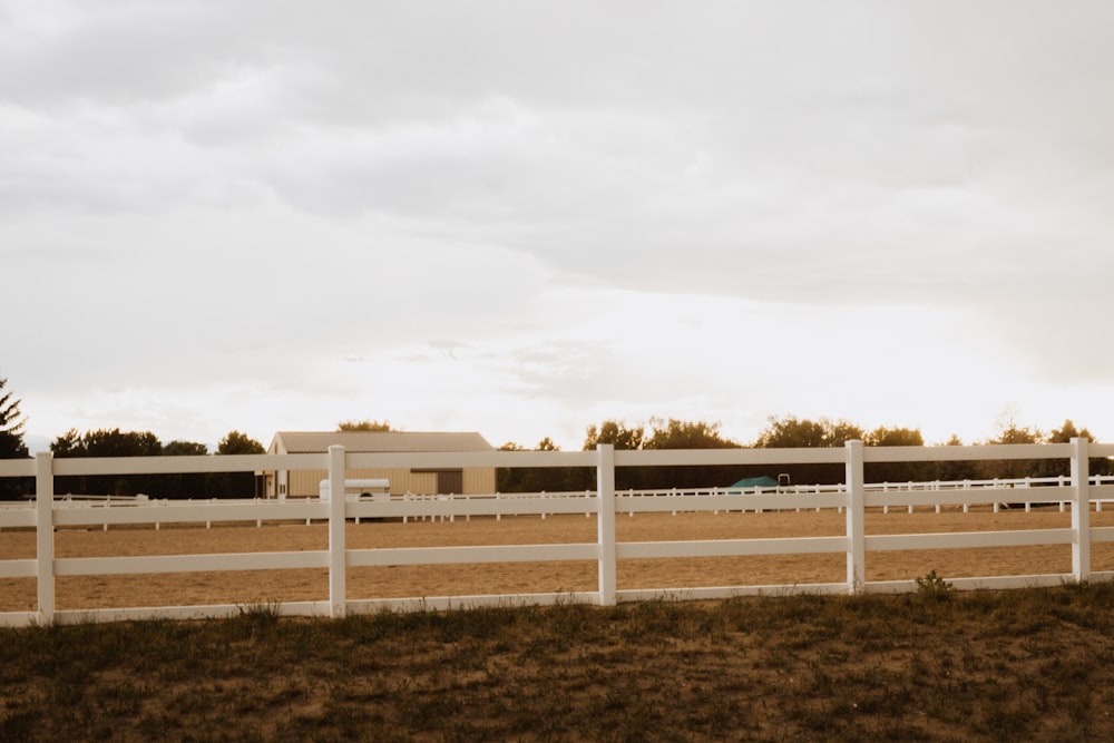 a white fence in front of a building