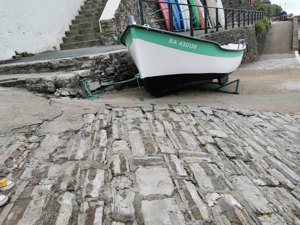 a boat tied to a stone wall