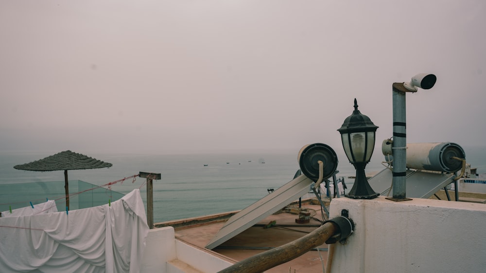 a boat with a lamp post and a body of water in the background