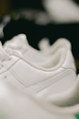 Close-up of polished shoes on a clean, white surface.