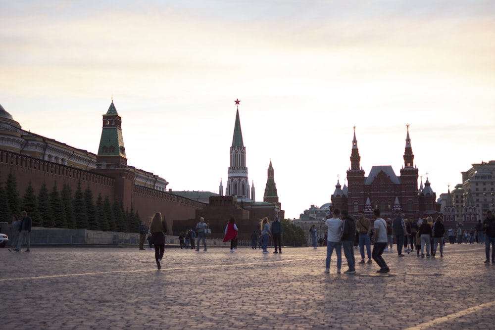 a group of people walking in front of a castle with Red Square in the background