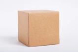 Close-up of a shipment box labeled with the Damasco Imports logo against a clean, gray background