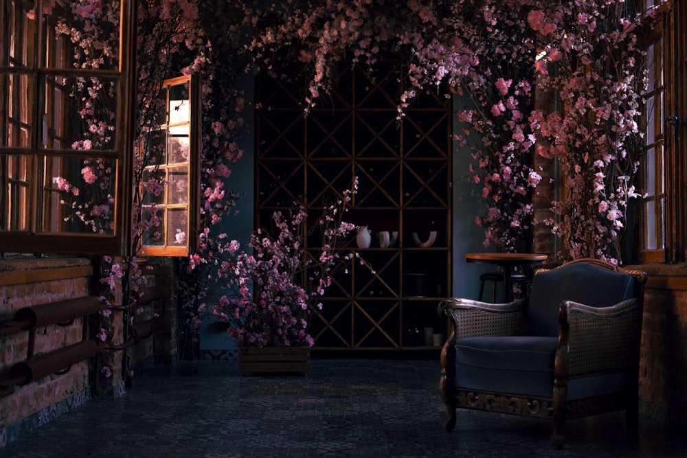 a chair and a table in a room with flowers on the walls