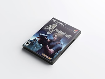 A PlayStation 2 game case featuring the cover art of a video game. The cover shows a character with blond hair holding a gun against a dark, eerie background. The title 'Resident Evil 4' is prominently displayed, along with the game developer's logo, Capcom, and a mature age rating.