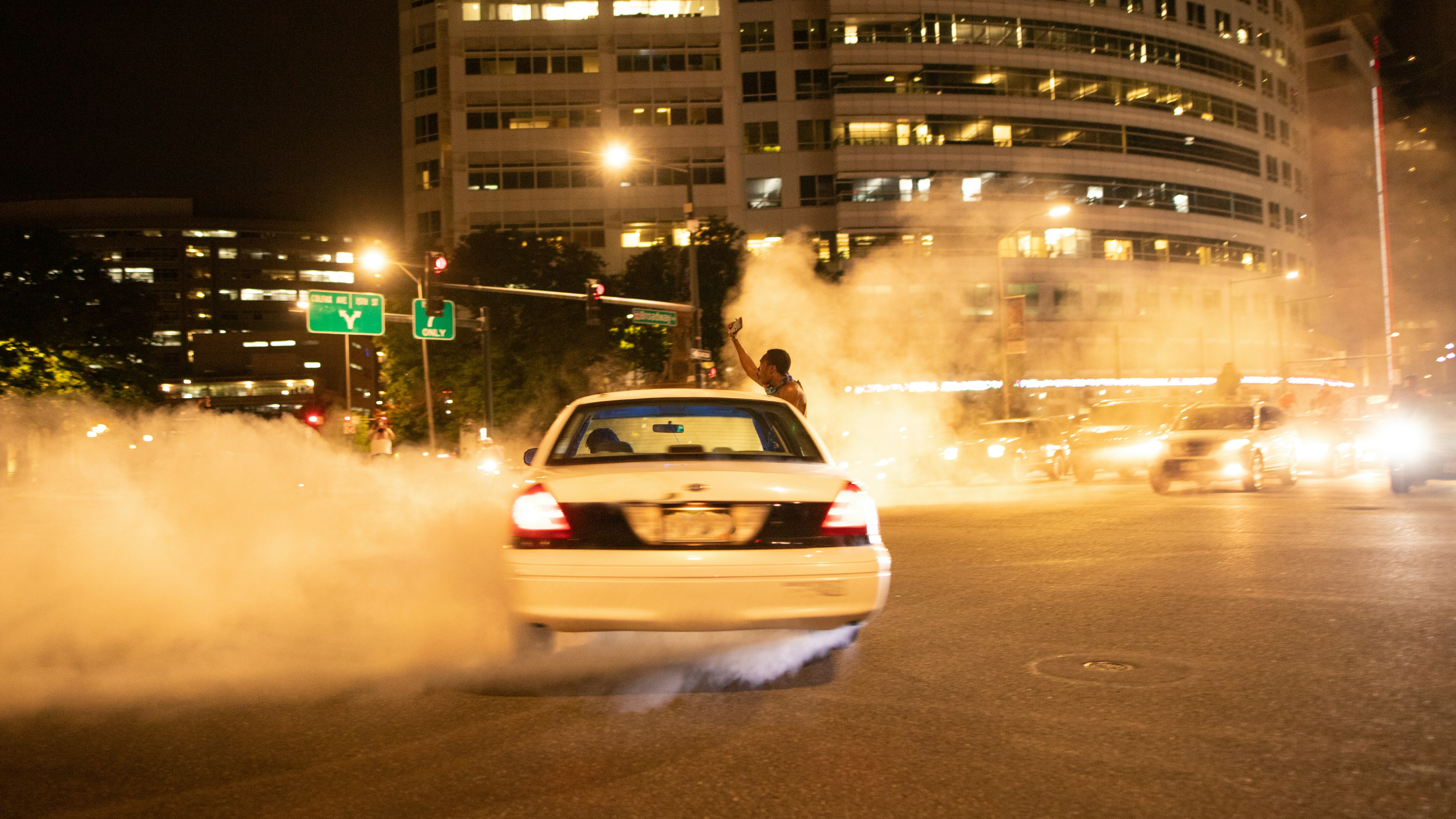 a car on a road with smoke coming out of it