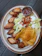 Close-up shot of a plate piled with crispy chicken wings and creamy macaroni &amp;amp;amp;amp;amp; cheese.