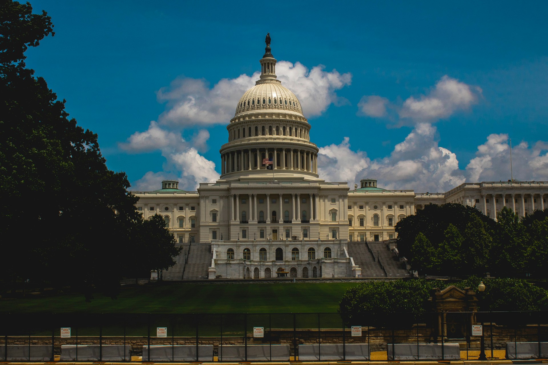 a large white building with a dome with United States Capitol in the background
