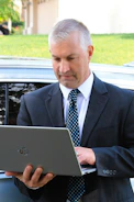 a man in a suit holding a tablet