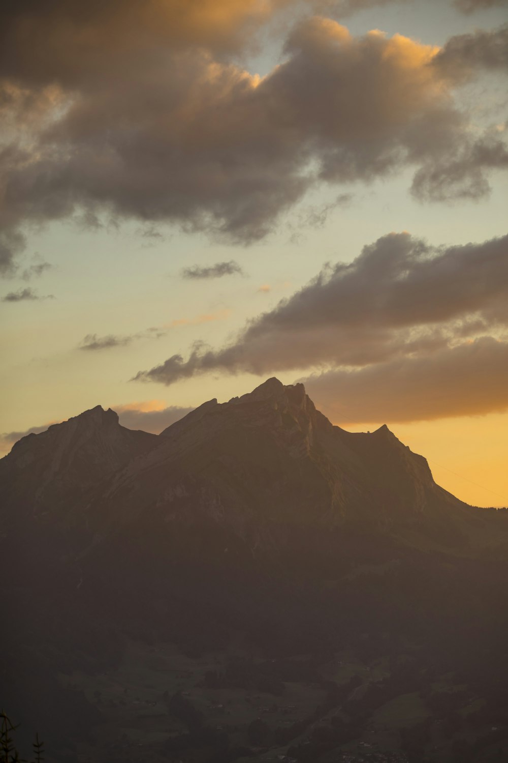 a mountain with clouds above it