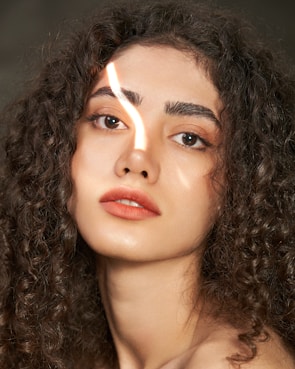 Close-up of Coach Reynaldo’s iconic curly wig under gym lights, highlighting his vibrant personality.