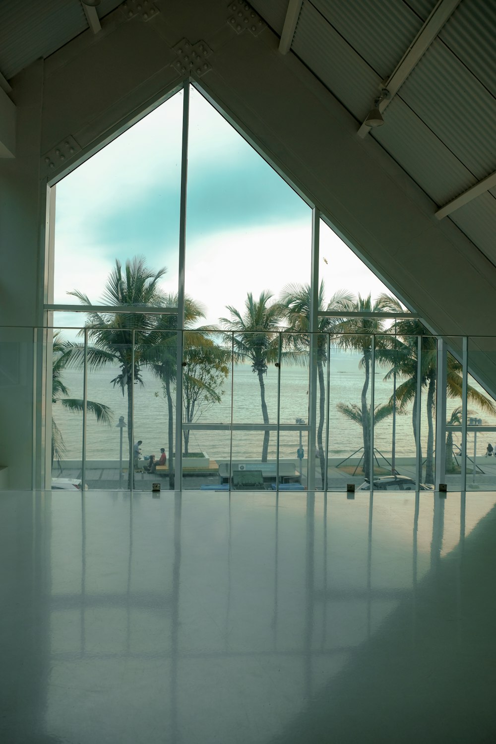 a room with a pool and palm trees