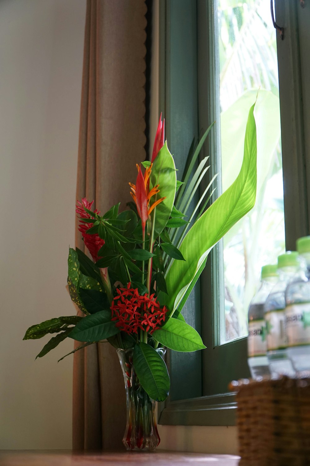 a vase with red flowers