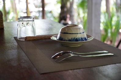 Set of biodegradable cutlery made from sugarcane fiber arranged on a linen cloth.