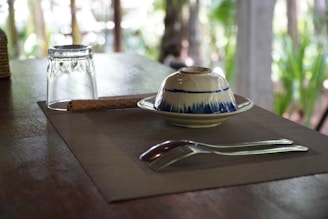 Set of biodegradable cutlery made from sugarcane fiber arranged on a linen cloth.
