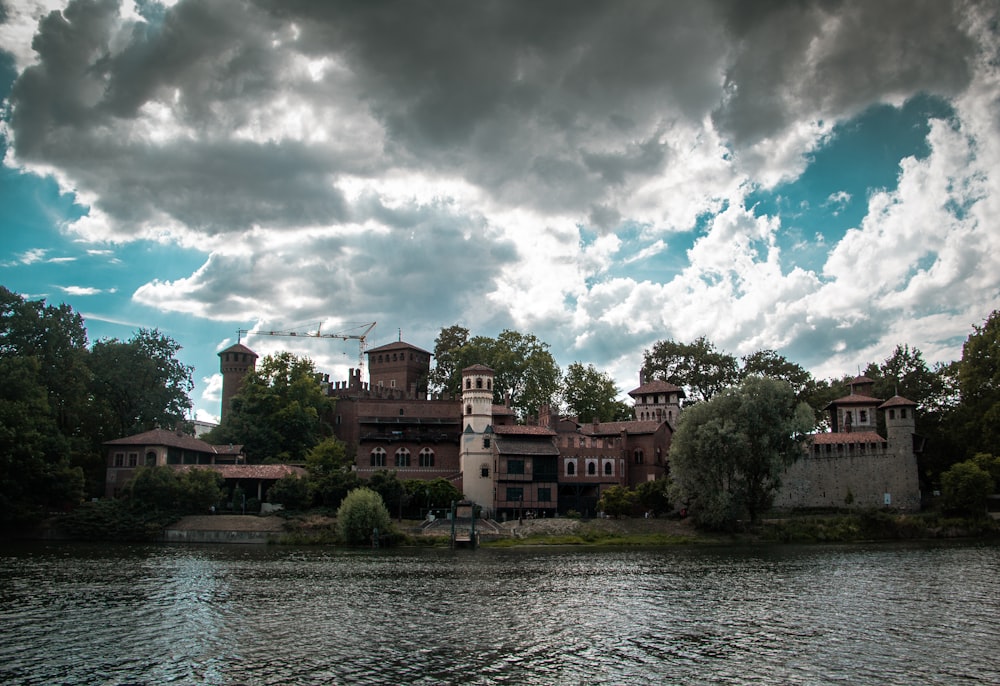 a body of water with buildings and trees around it