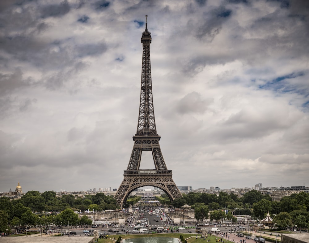 a tall metal tower with Eiffel Tower in the background