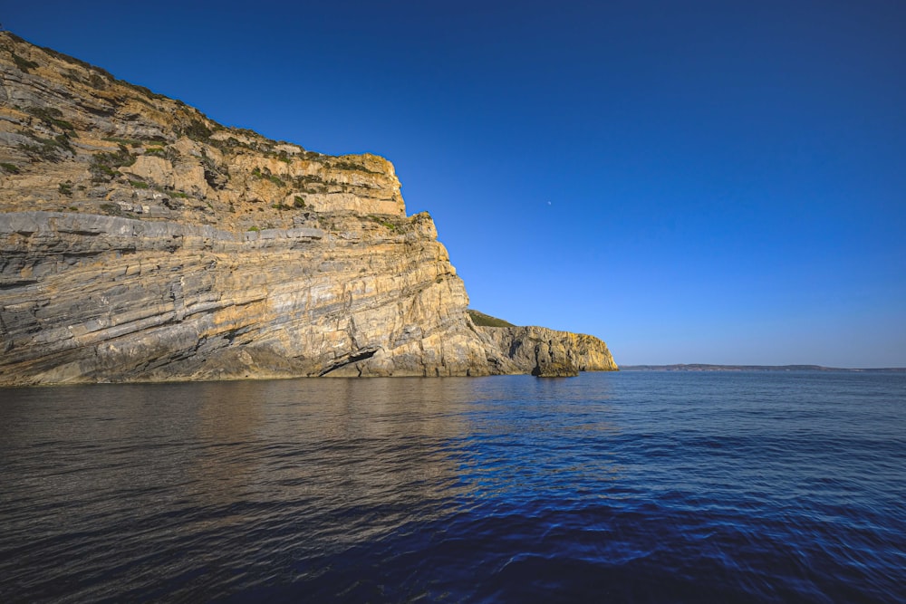 a cliff next to the water