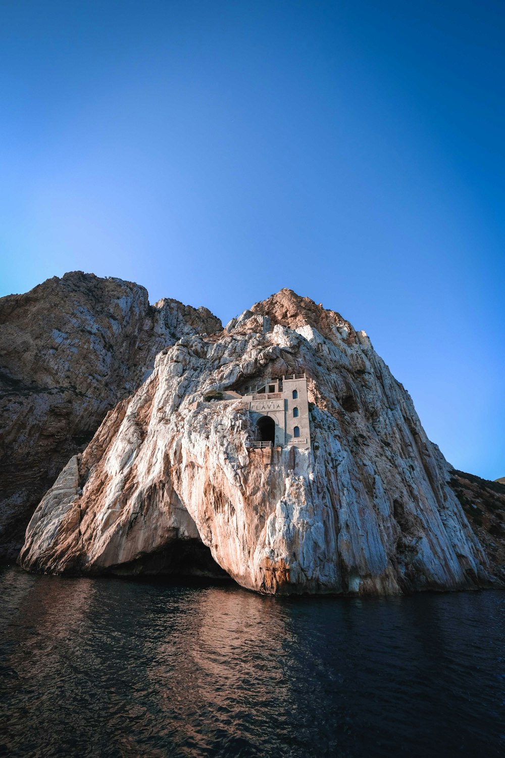 a stone building on a cliff