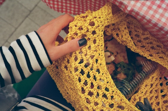 a person holding a piece of food