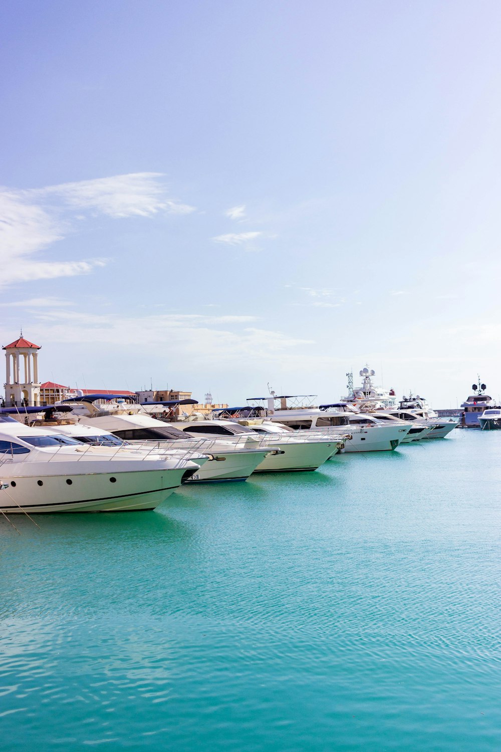 a group of boats sit in a harbor