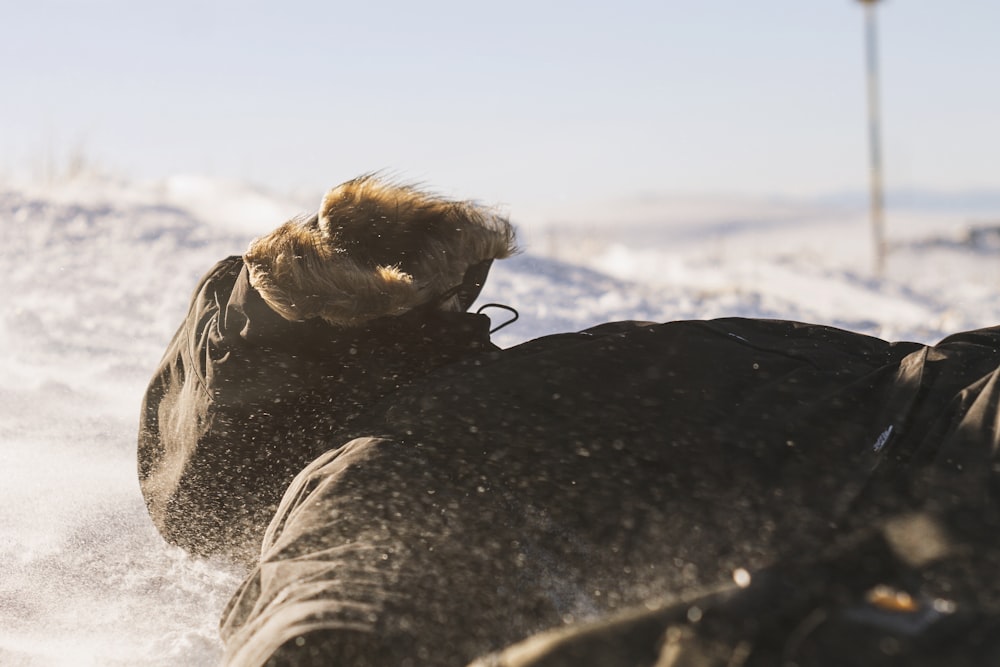 a person lying on the snow