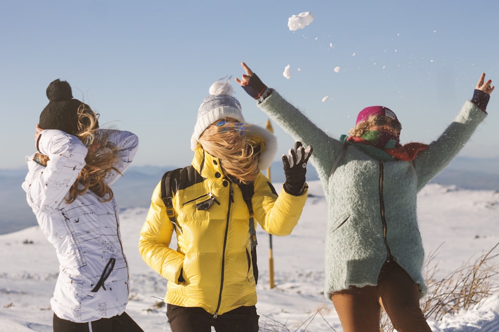a group of people throwing snow