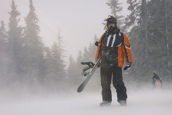 a snowboarder carrying his board
