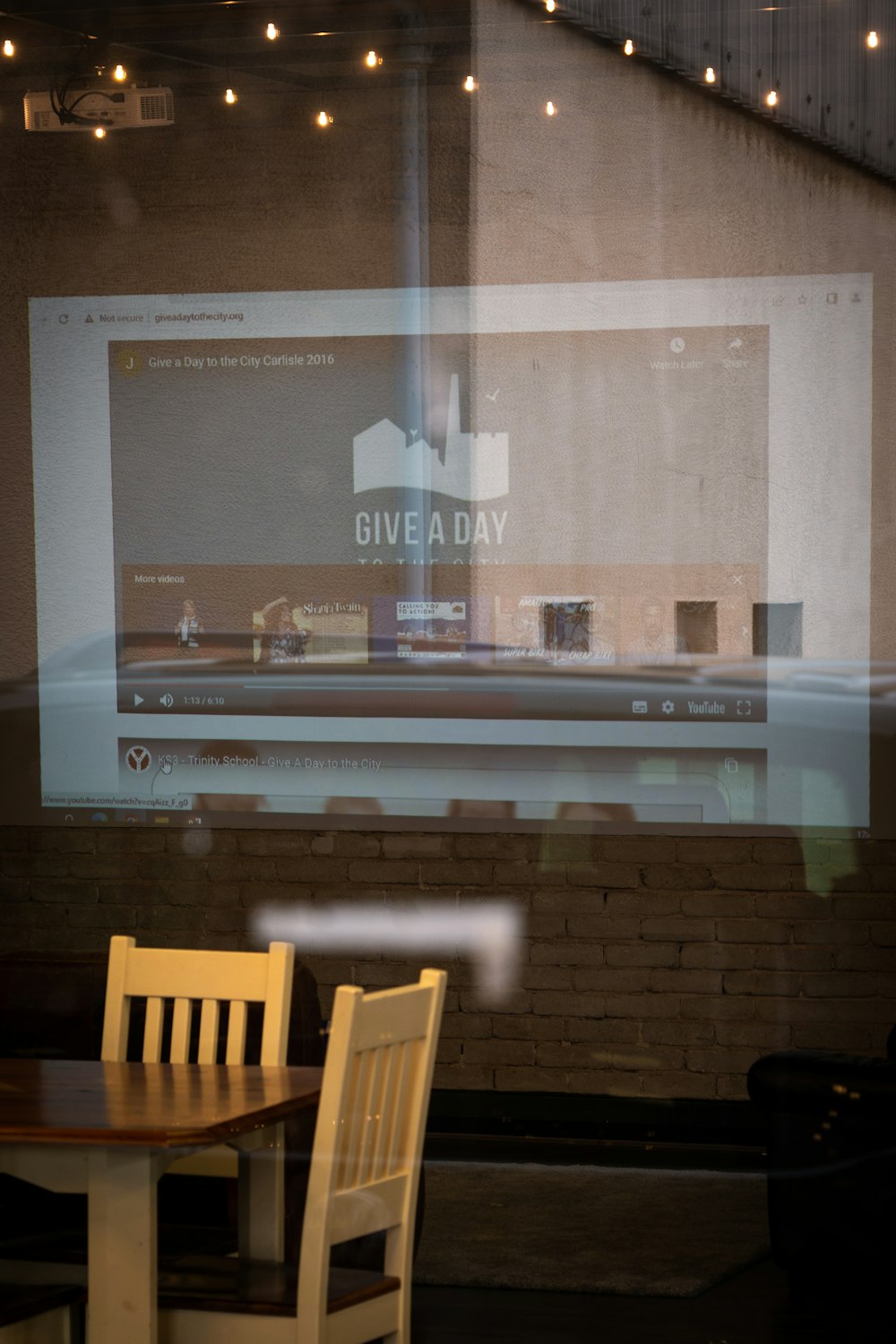 a large screen with chairs in front of it