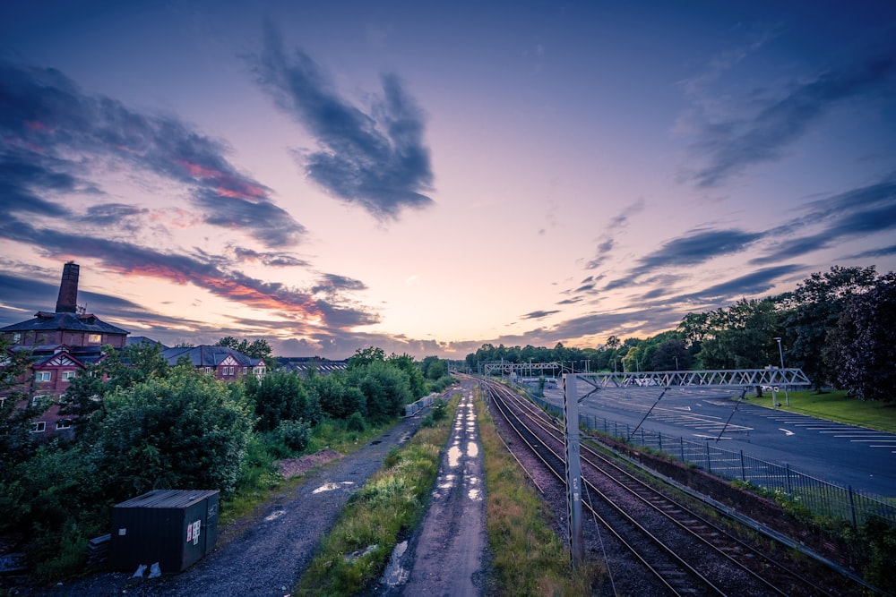 a train track with trees and buildings