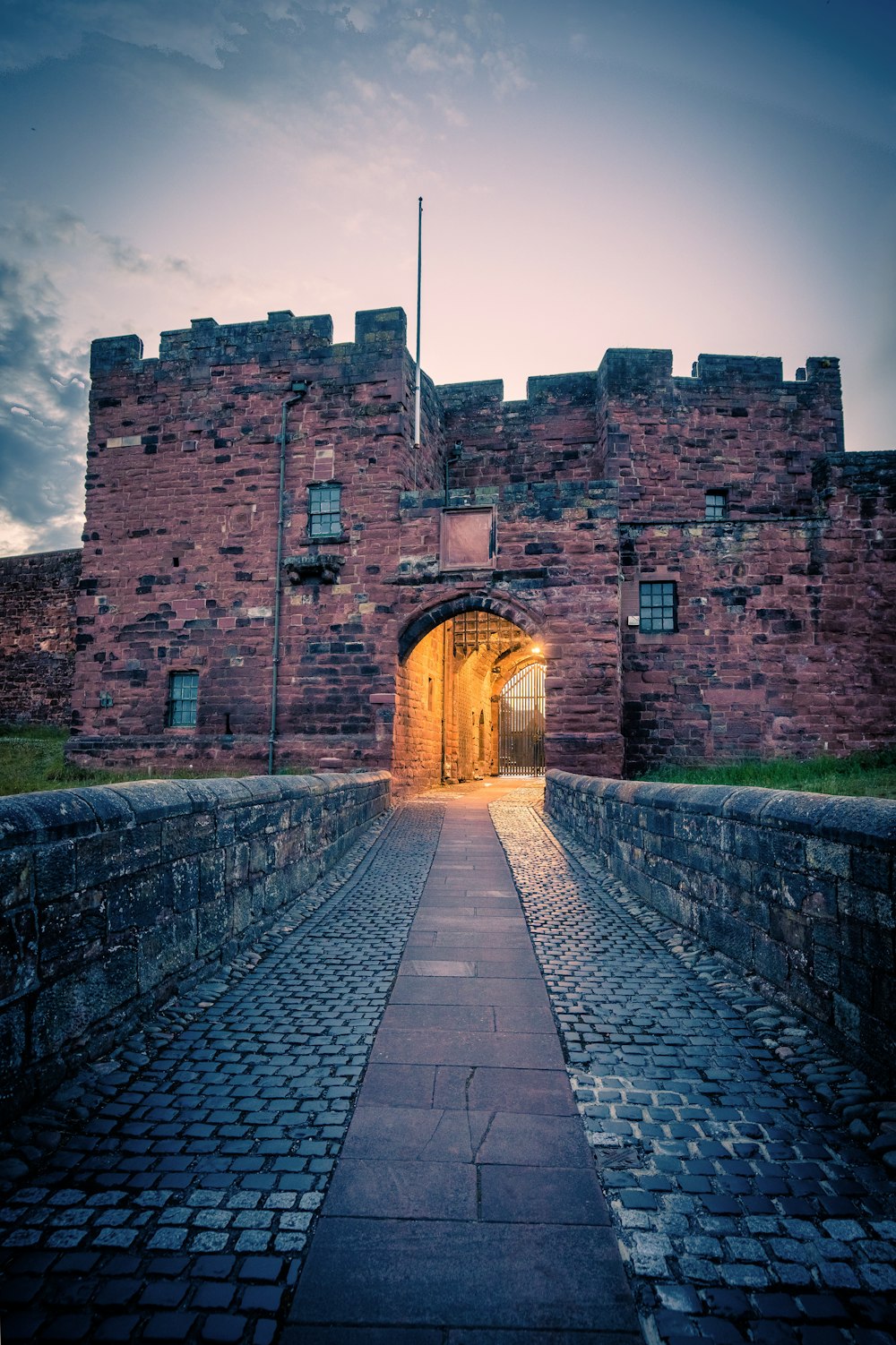 a brick building with a stone walkway