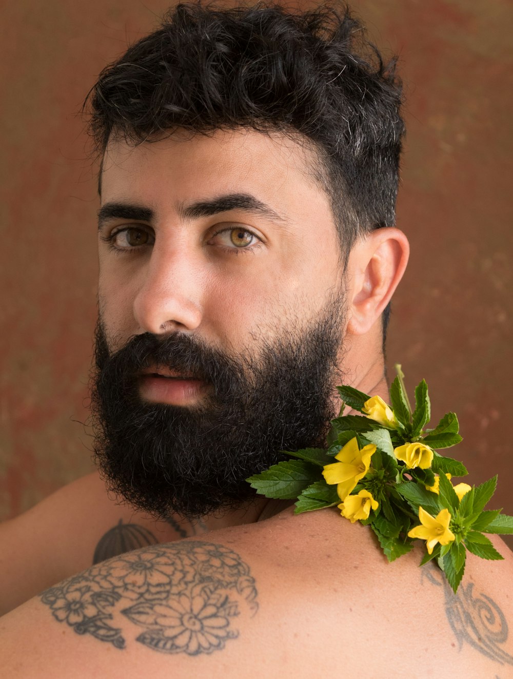 a man with a beard and tattoos