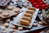 Close-up of pharmaceutical capsules arranged neatly on a white surface.