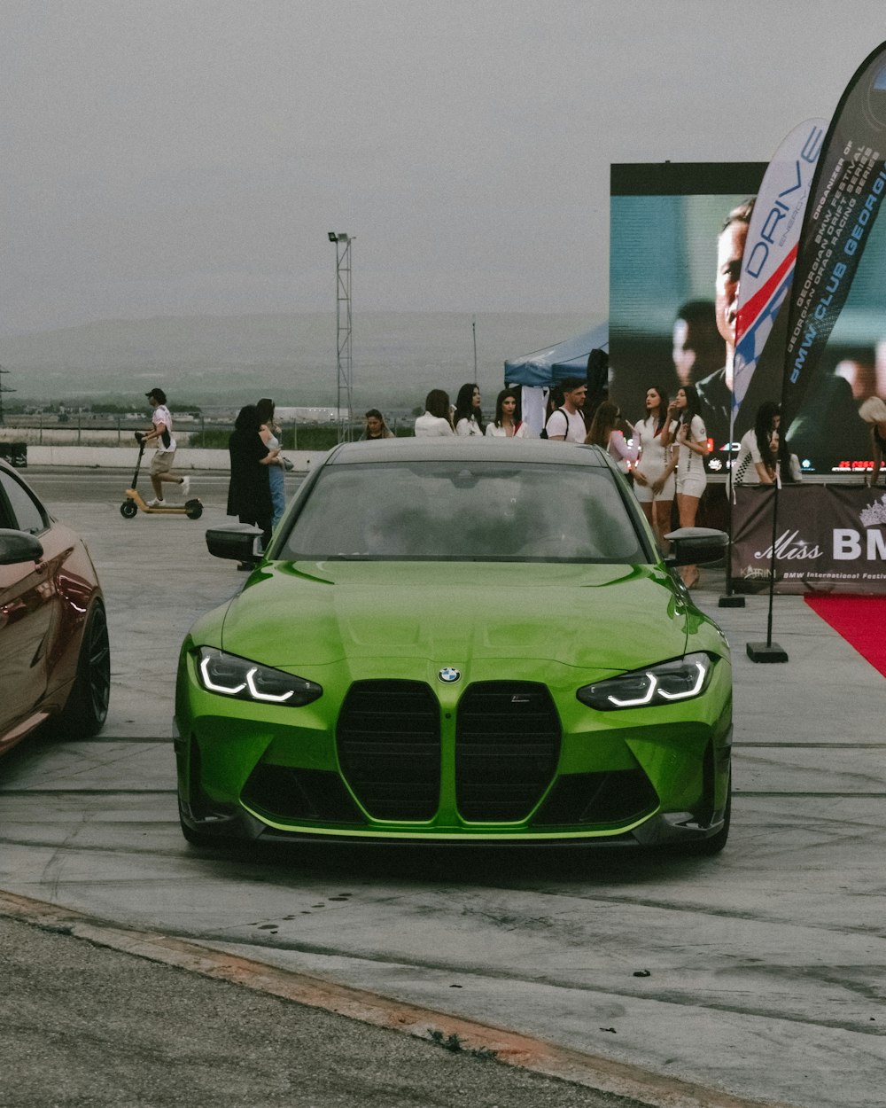 a green car parked on a street