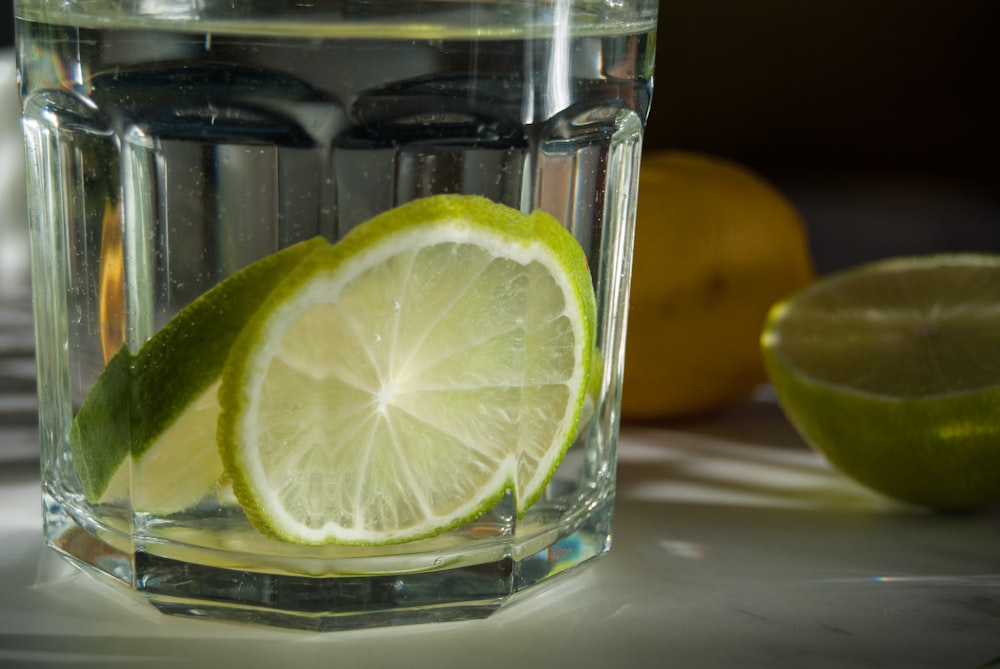a glass of water with lemons