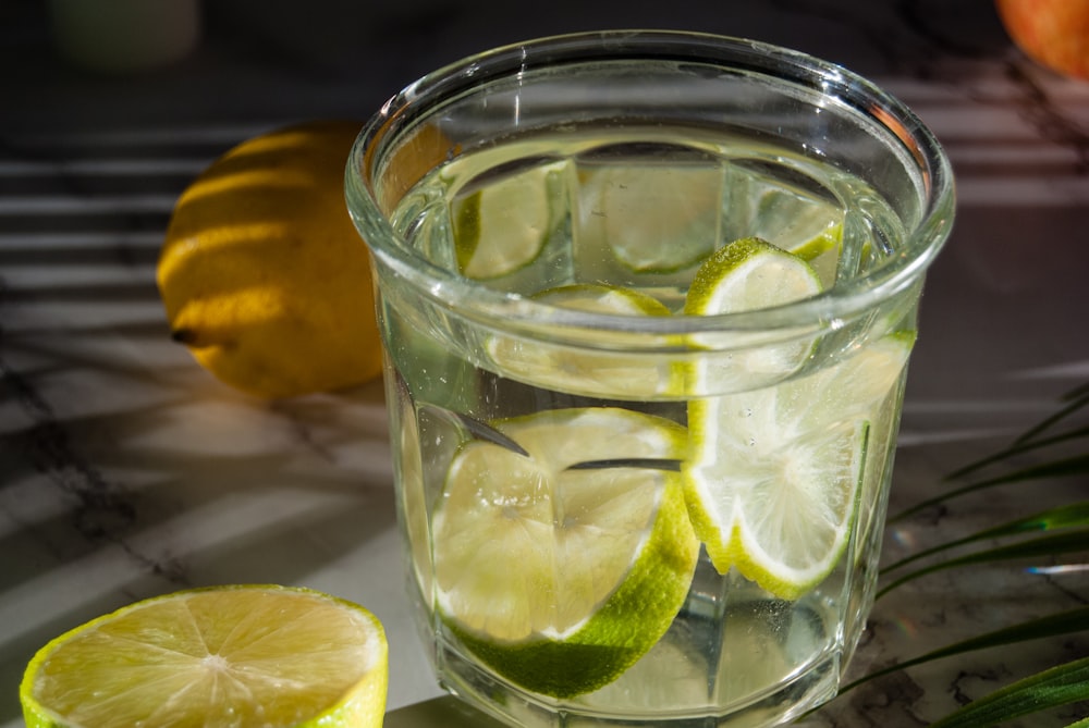 a glass of water with lemons